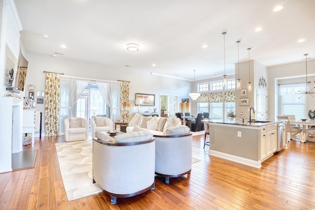 living room featuring light hardwood / wood-style floors and sink