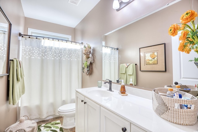 full bathroom featuring toilet, shower / bath combo, and vanity