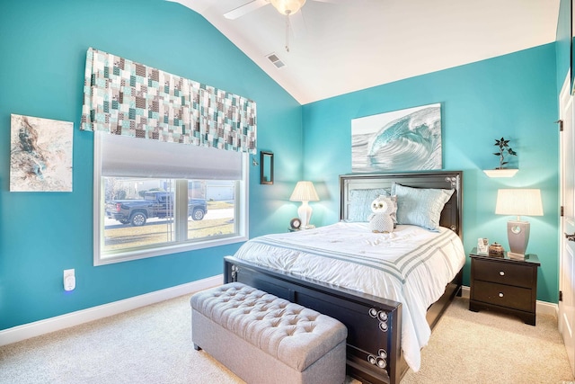 bedroom with ceiling fan, vaulted ceiling, and light colored carpet