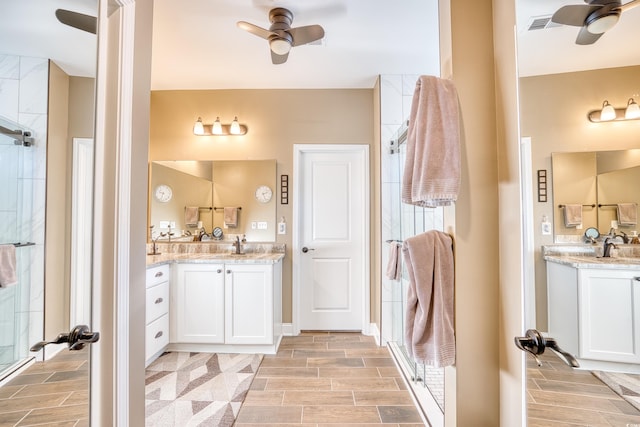 bathroom featuring ceiling fan, walk in shower, and vanity