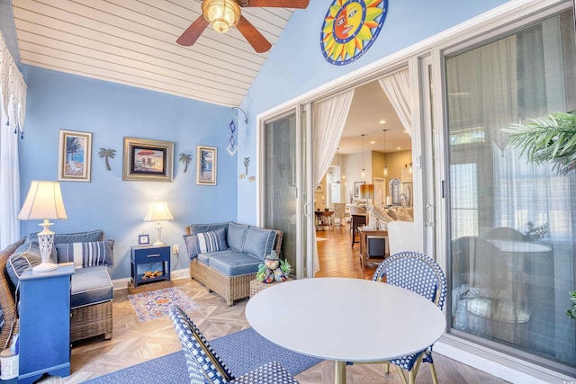 interior space with ceiling fan, parquet floors, and vaulted ceiling