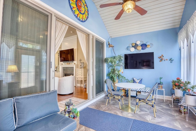 sunroom / solarium with lofted ceiling and ceiling fan