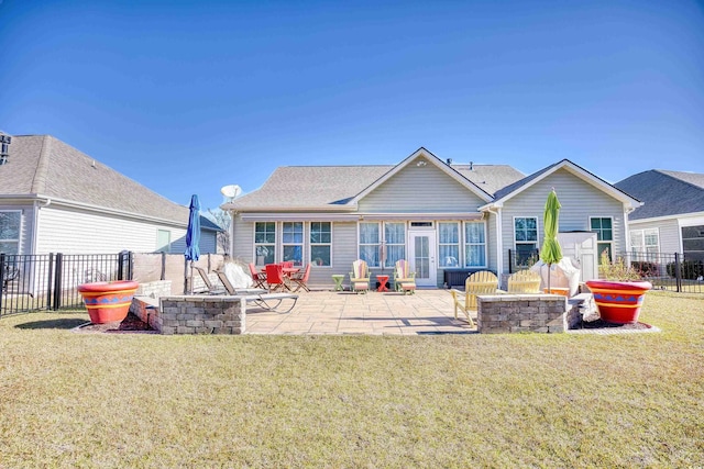 rear view of property with an outdoor fire pit, a patio, and a yard