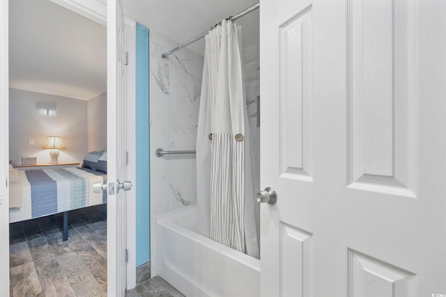 bathroom featuring wood-type flooring and shower / bathtub combination with curtain