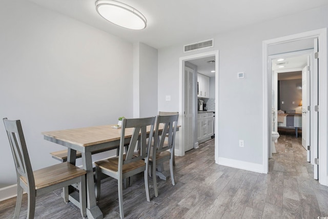 dining area featuring sink and hardwood / wood-style floors