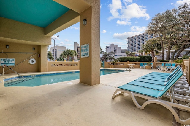 view of swimming pool featuring a patio area