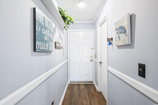 entryway featuring a textured ceiling, crown molding, and dark wood-type flooring