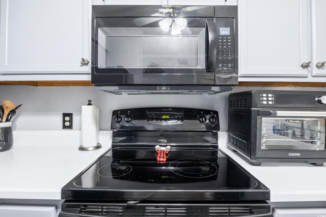 kitchen with white cabinets and black appliances