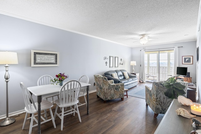 living room featuring a textured ceiling, ceiling fan, ornamental molding, and dark wood-type flooring