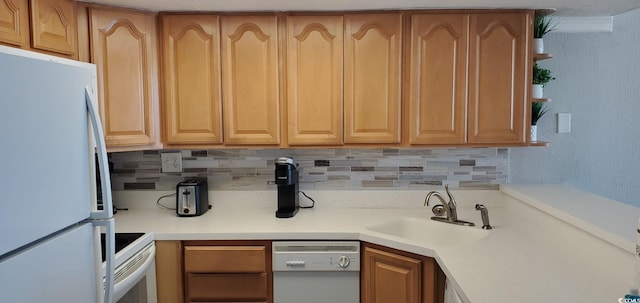 kitchen featuring white appliances, tasteful backsplash, and sink