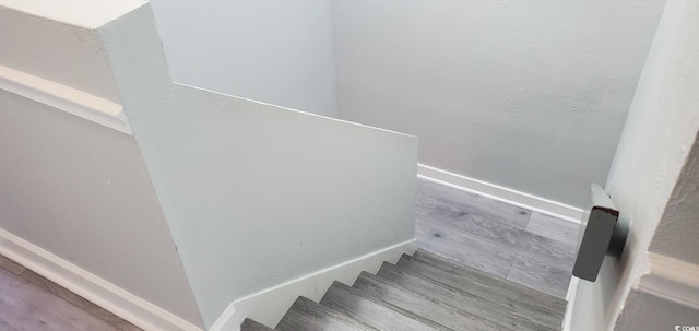 stairs featuring hardwood / wood-style floors