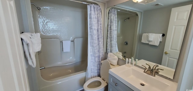 full bathroom featuring toilet, shower / bath combo with shower curtain, and vanity