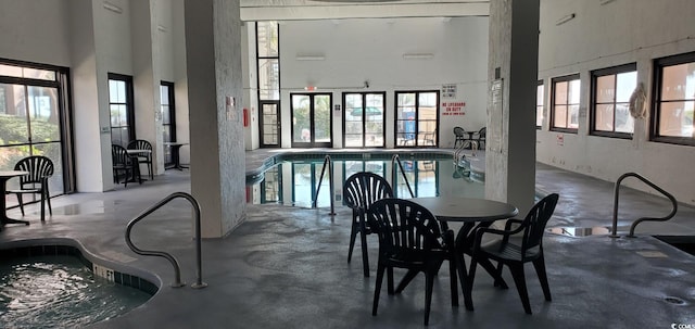 dining space with a high ceiling and concrete floors