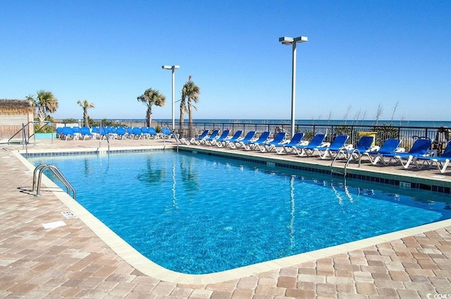 view of pool featuring a water view