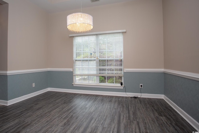 unfurnished room with visible vents, dark wood-type flooring, and baseboards