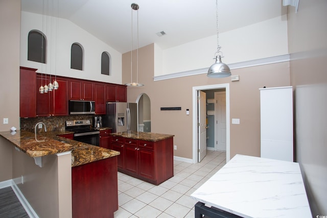 kitchen with visible vents, backsplash, dark brown cabinets, light tile patterned floors, and stainless steel appliances