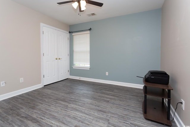 spare room featuring visible vents, baseboards, and wood finished floors