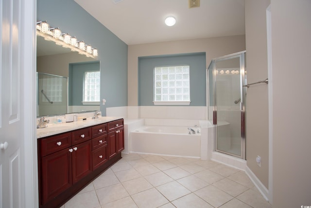 bathroom with a sink, a garden tub, a stall shower, and double vanity