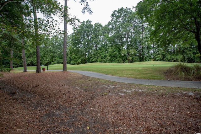 view of community featuring a yard and golf course view