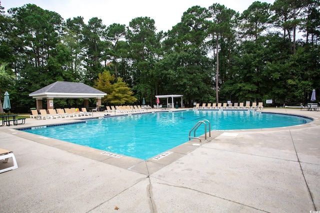 pool featuring a gazebo, a patio, and fence