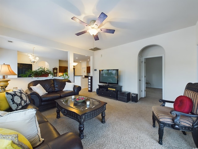 living room with carpet floors and ceiling fan with notable chandelier