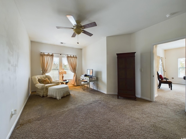 sitting room featuring ceiling fan and carpet floors