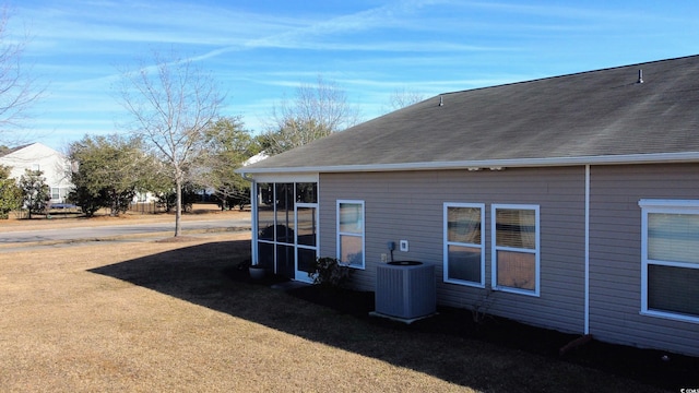 view of side of home with central AC unit