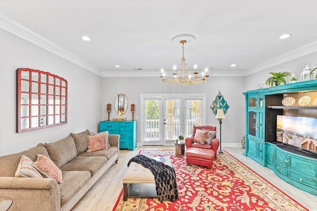 living room featuring a notable chandelier, light wood-type flooring, and ornamental molding