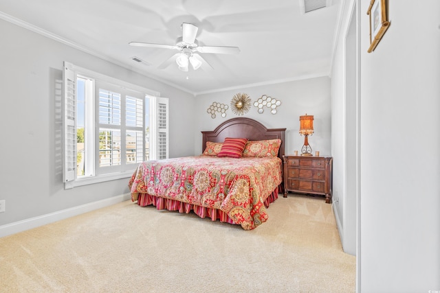 bedroom featuring ceiling fan, crown molding, and carpet flooring