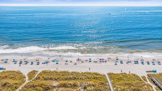 birds eye view of property featuring a view of the beach and a water view