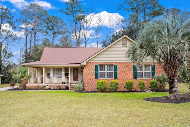 ranch-style house with a front yard and covered porch