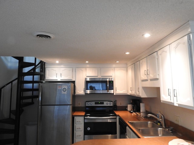 kitchen featuring sink, white cabinetry, and appliances with stainless steel finishes