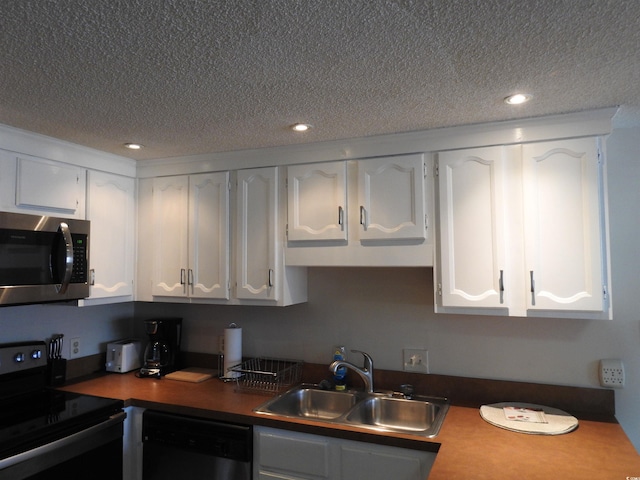 kitchen with white cabinets, electric range oven, and black dishwasher