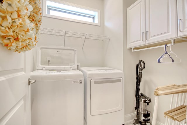 washroom with cabinets and independent washer and dryer