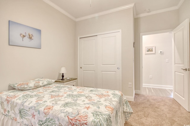 carpeted bedroom featuring ornamental molding and a closet