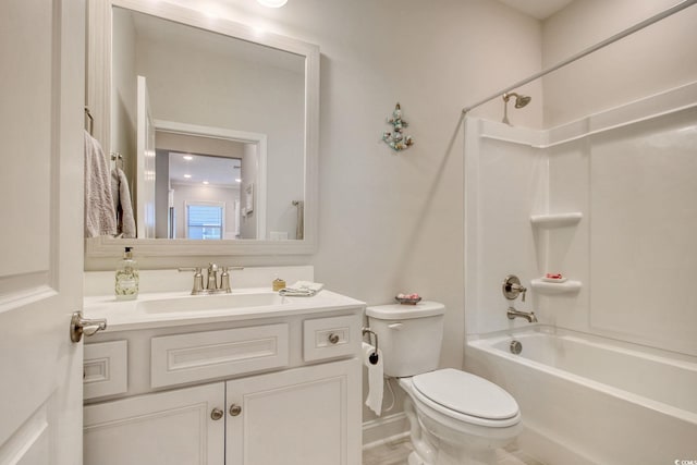 full bathroom featuring tub / shower combination, vanity, and toilet