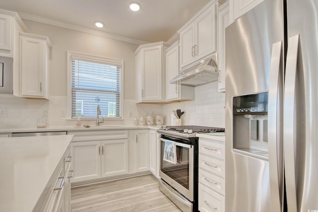 kitchen featuring stainless steel appliances, white cabinetry, and sink