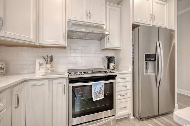 kitchen featuring stainless steel appliances, decorative backsplash, light wood-type flooring, white cabinets, and ventilation hood