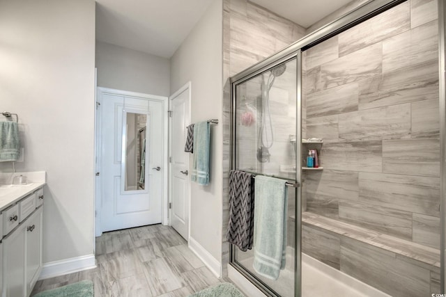 bathroom featuring vanity and a shower with shower door