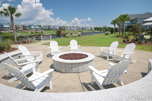 view of patio with a water view and an outdoor fire pit