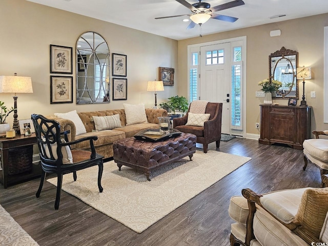 living room featuring ceiling fan and dark hardwood / wood-style floors