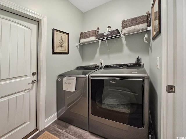 laundry area featuring washing machine and dryer and dark hardwood / wood-style flooring