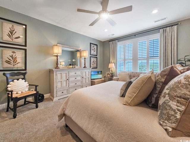 bedroom with ceiling fan and light colored carpet