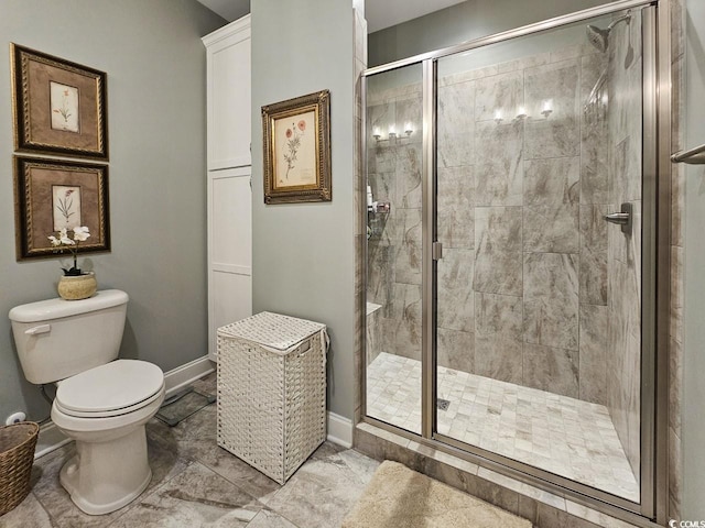 bathroom featuring an enclosed shower and toilet