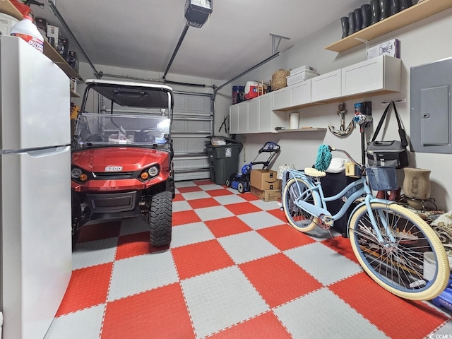 garage with electric panel, a garage door opener, and fridge