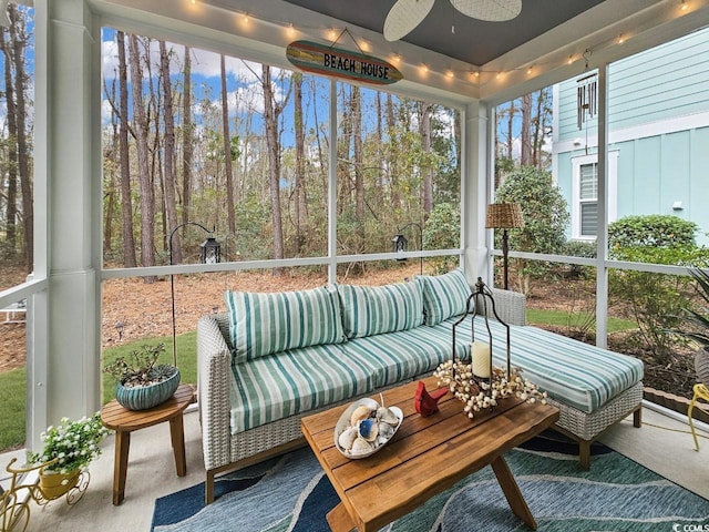 sunroom featuring ceiling fan