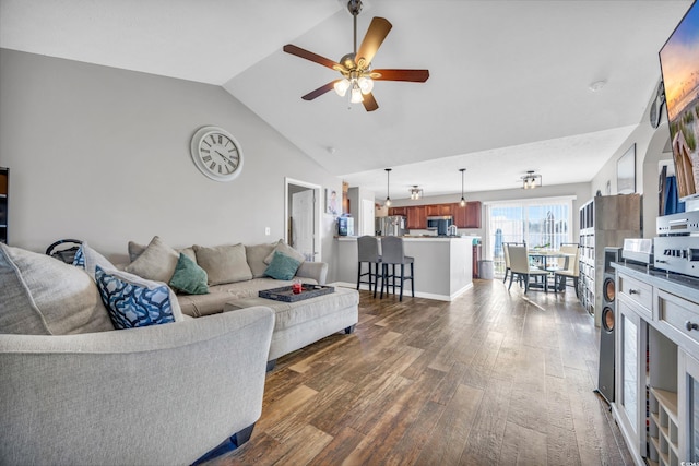 living room with ceiling fan, vaulted ceiling, and dark hardwood / wood-style floors