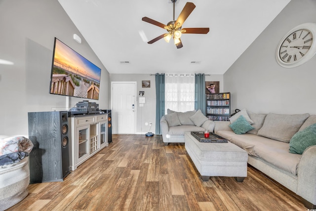 living room with ceiling fan, hardwood / wood-style floors, and vaulted ceiling