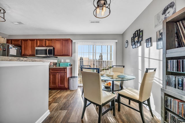 dining area featuring dark hardwood / wood-style flooring