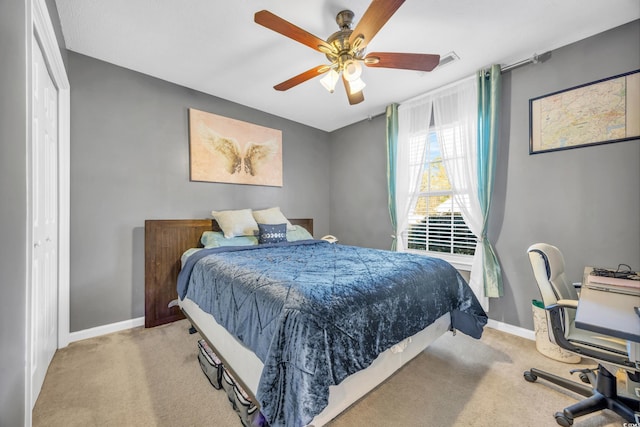 bedroom featuring light carpet, a closet, and ceiling fan